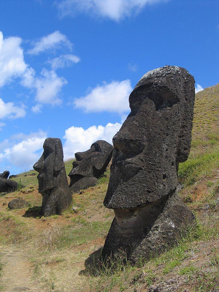 Take A Look At This Piece Of Art:Large Heads Carved Out Of Stone Rest In Various Positions On A Steep,